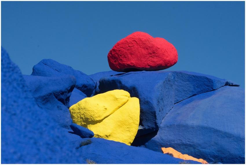 Brightly colored rocks painted in vivid blue, red,