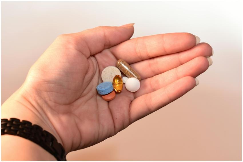 A close-up image of a human hand holding assorted