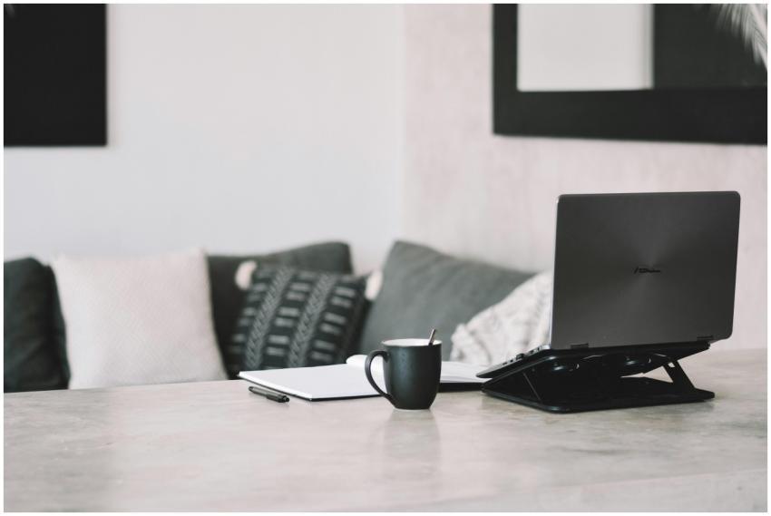 A minimalist home office setup with a laptop and c