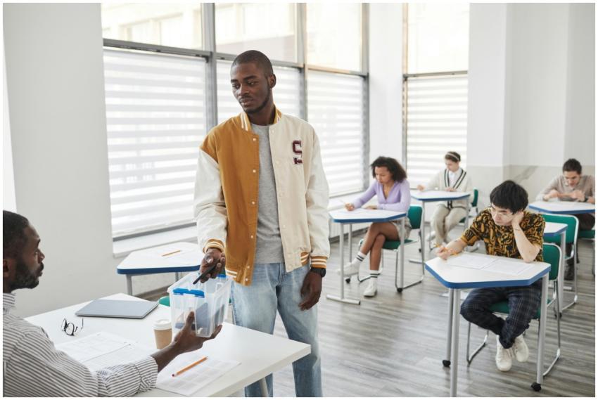 Group of students taking exams in a modern classro