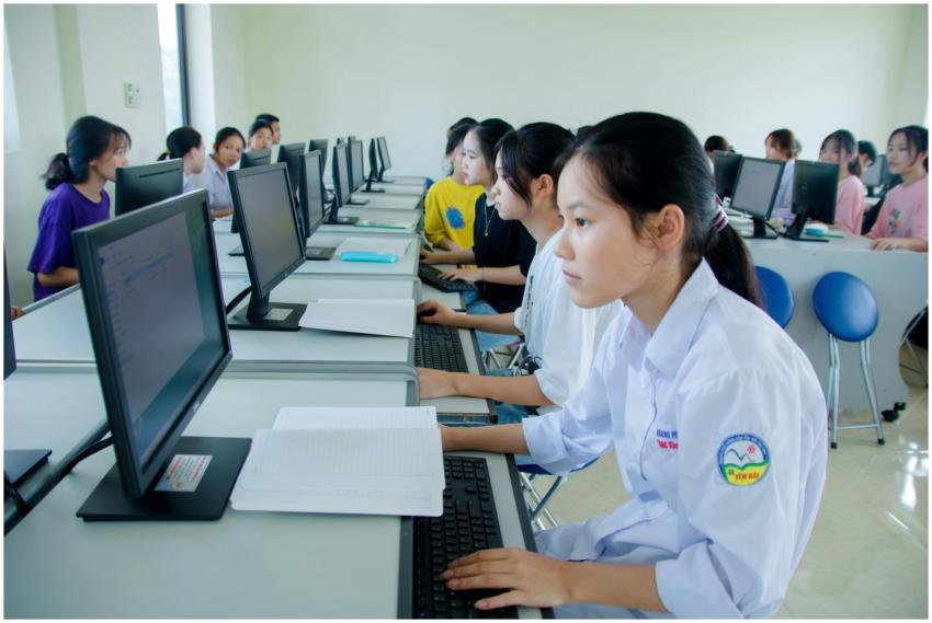 Students engaged in study at a computer lab, focus