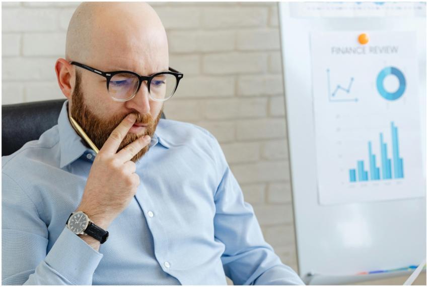 Business analyst in a blue shirt analyzing financi