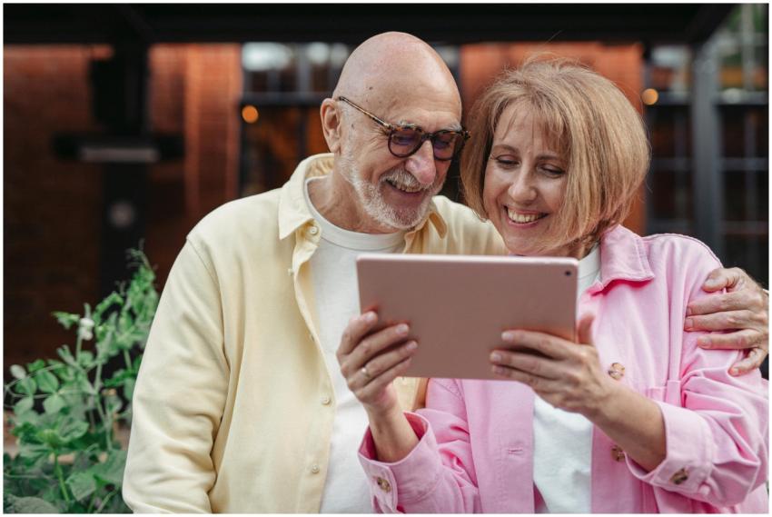 Happy senior couple using a tablet together, enjoy