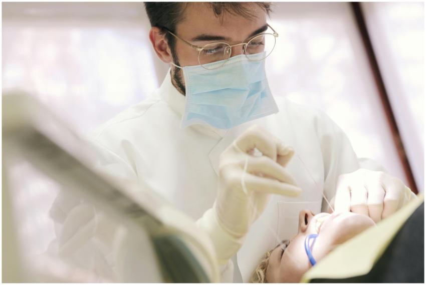 Close-up of a dentist in a face mask working on a