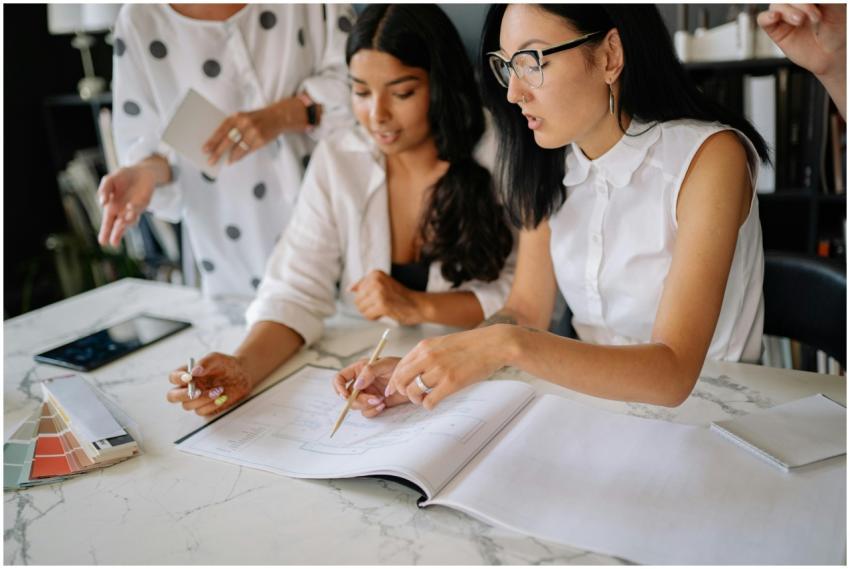 Professional women discussing project details duri