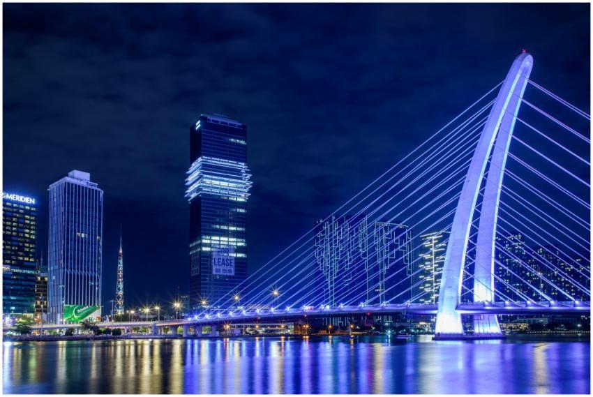 Night view of a modern illuminated bridge with sky