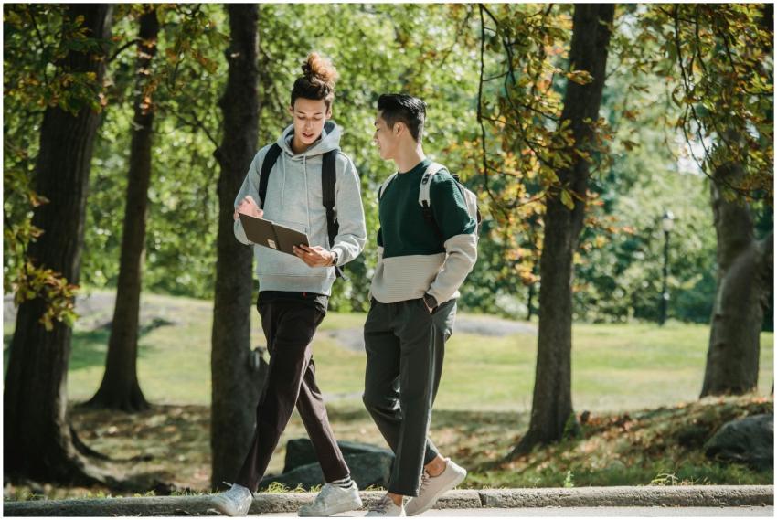 Two university students walking and discussing aca