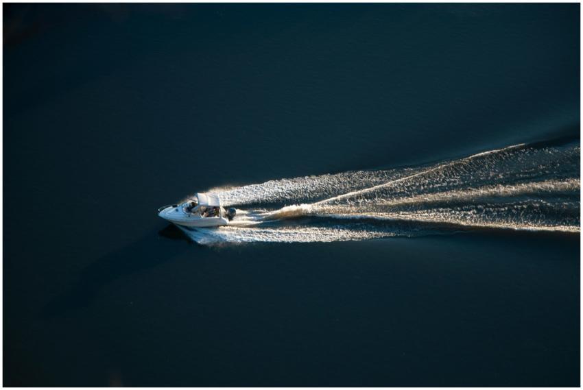 Aerial shot of a speedboat cruising on a calm open