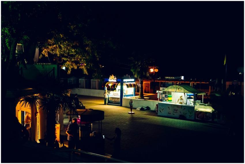 A vibrant night scene featuring illuminated food s