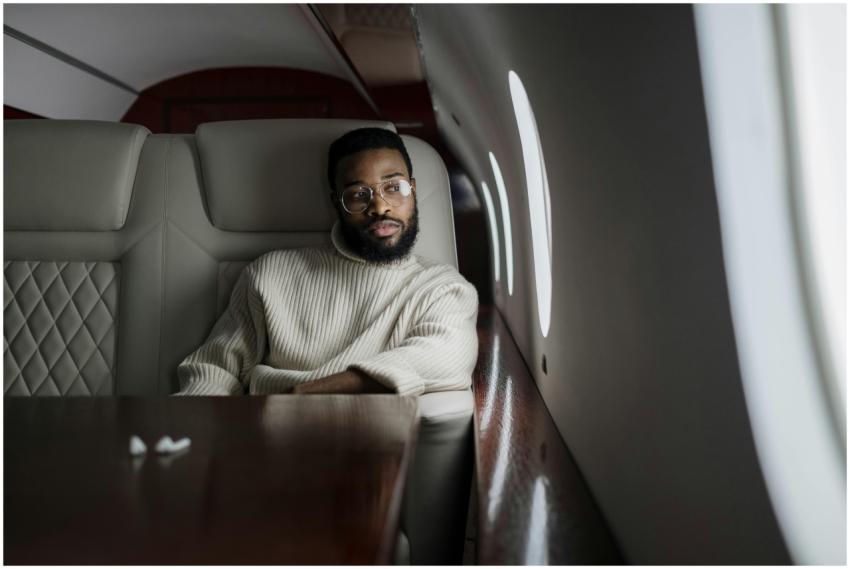 A man in a white sweater relaxes in the luxurious