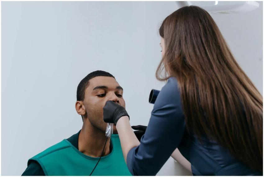 Dentist performing an X-ray scan on a patient in a