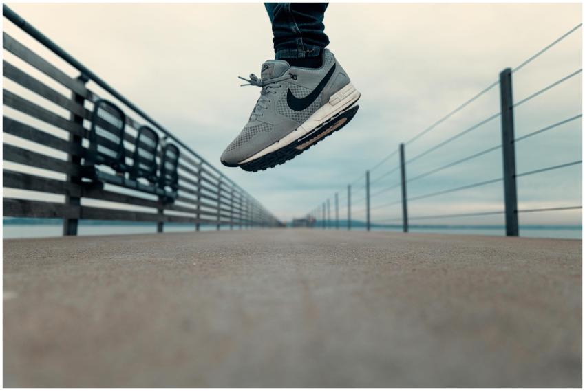 A close-up of a person jumping on a pier at Altnau