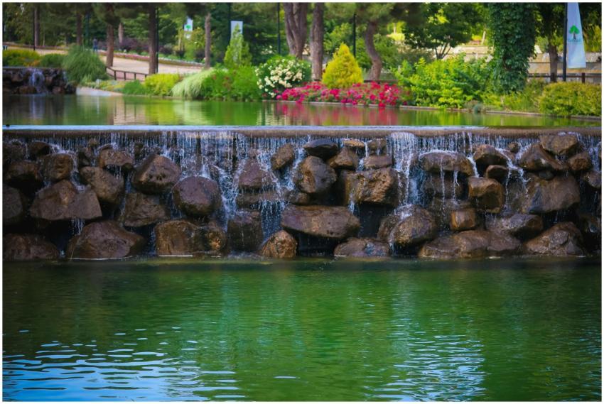 A serene waterfall over rocks in Şehitkamil Park,