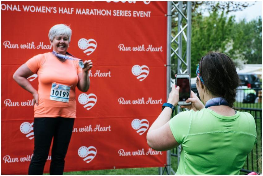 Woman proudly shows medal after completing women's