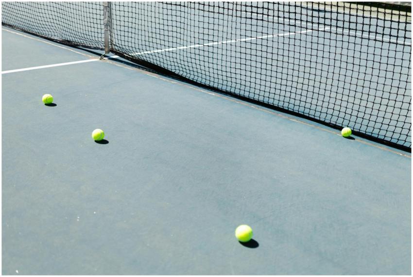 A tennis court featuring a net and several tennis