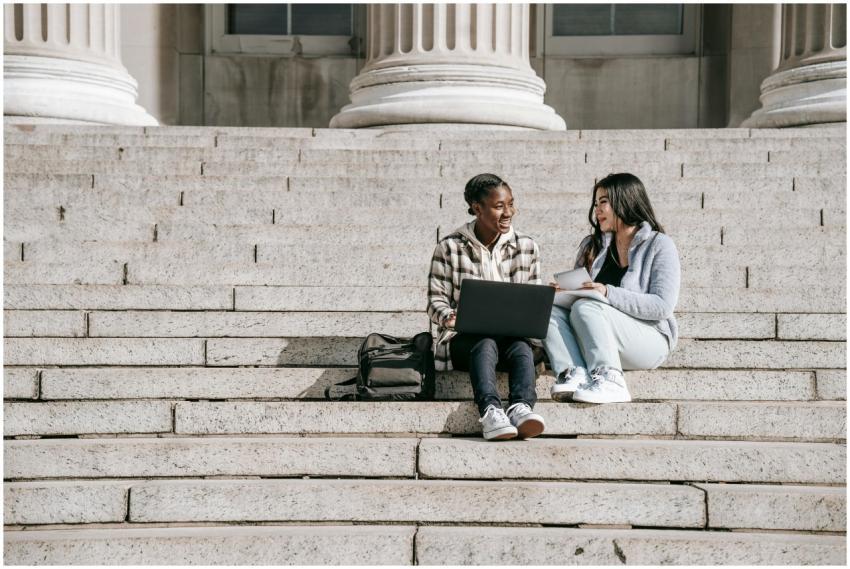 Full body positive multiracial female students sit