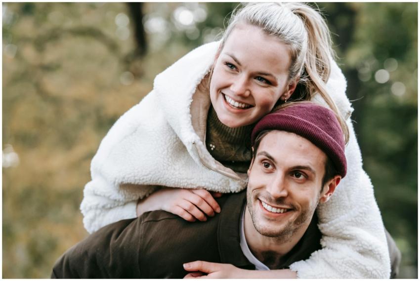 Cheerful smiling crop girlfriend embracing positiv
