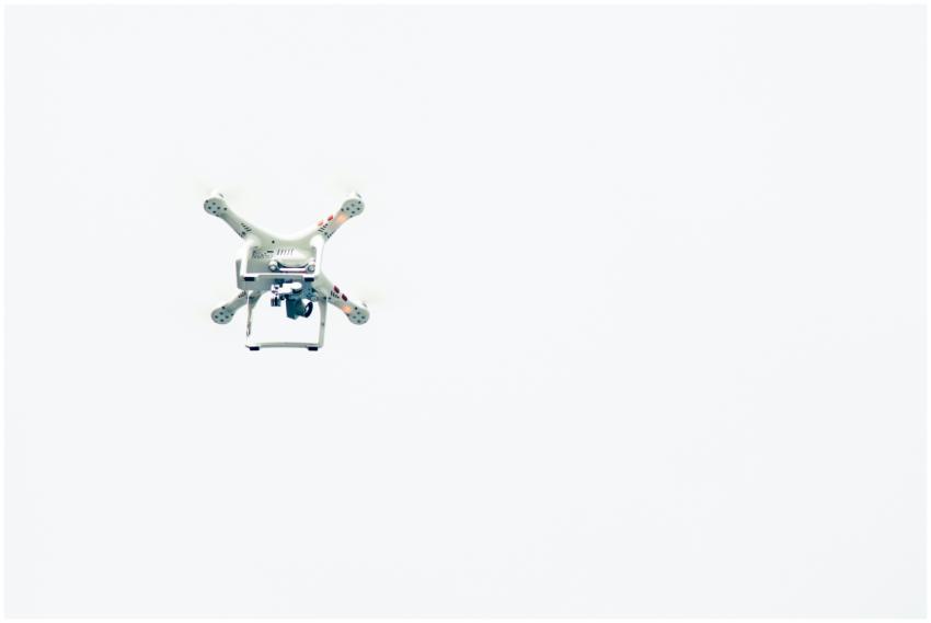 A minimalist capture of a drone flying against a c