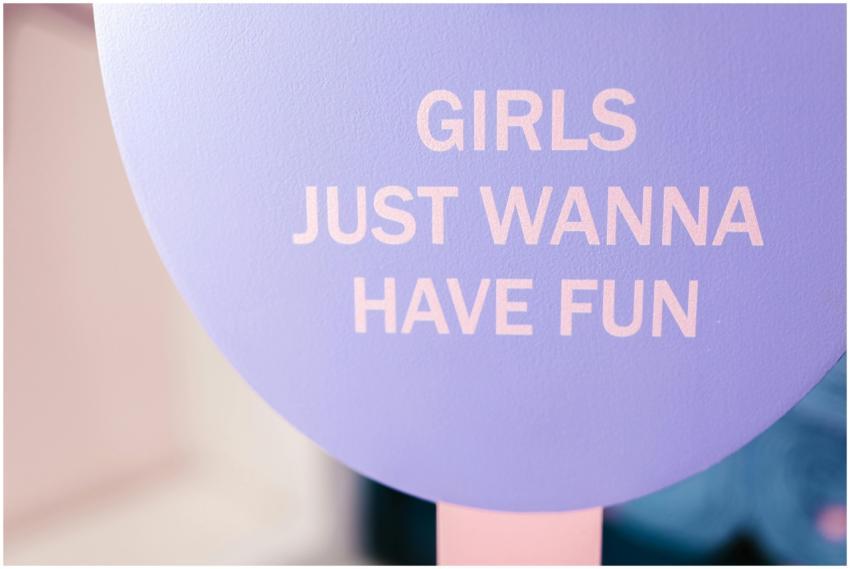 Vibrant purple sign with 'Girls Just Wanna Have Fu