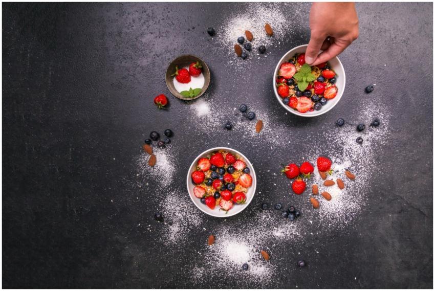 Fresh strawberries, blueberries, almonds in bowls