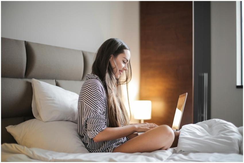 Young woman enjoying leisure time on her laptop in