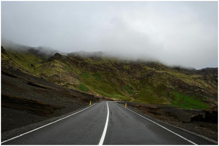 A foggy mountain road in Iceland, offering a seren