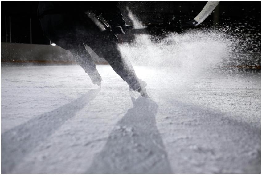 High-energy ice hockey player in action, creating