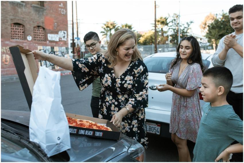 Happy family enjoying a pizza outing together in a