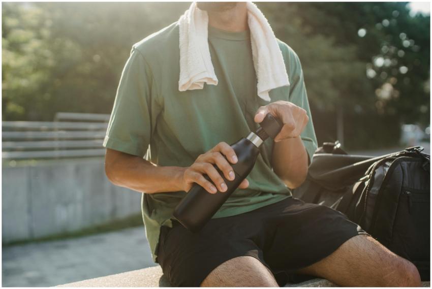 Close-up of a man sitting outdoors with a reusable