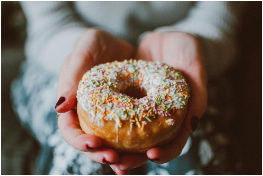 Close-up photo of a donut with colorful sprinkles