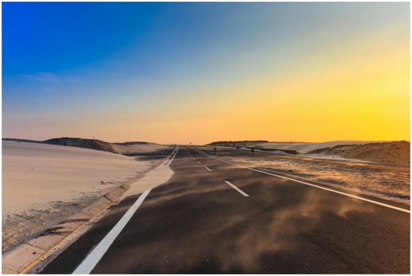 A long desert highway stretches into the distance