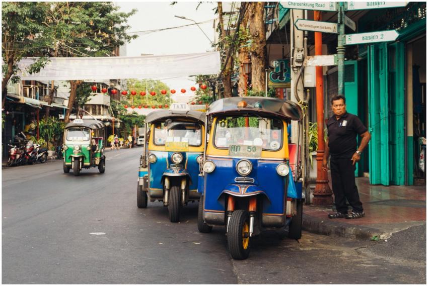 Iconic tuk tuks parked on a bustling street in Ban