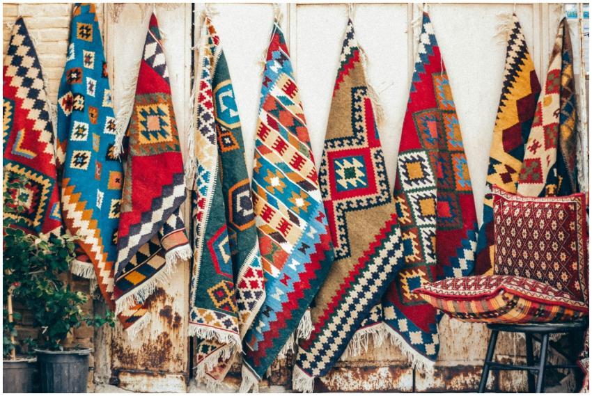 Vibrant Persian rugs hung for display in Shiraz, s