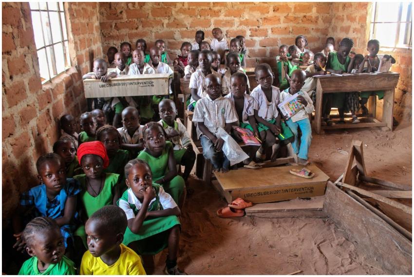 A group of children in a rustic classroom environm