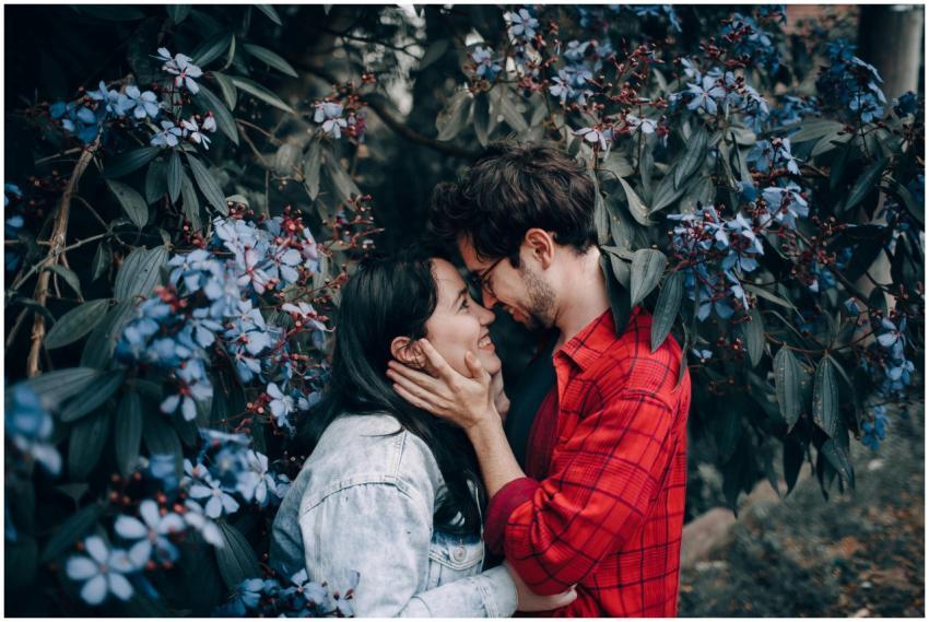 A young couple in love embraces amidst vibrant flo