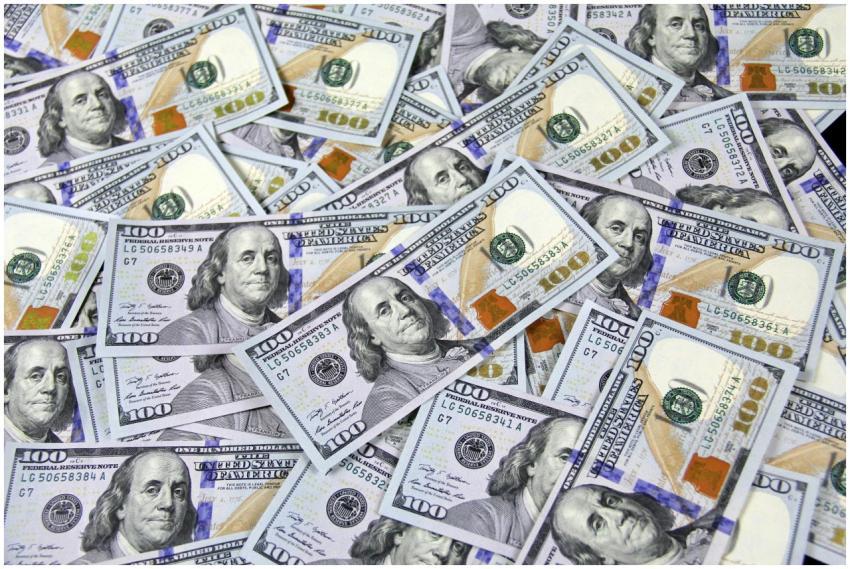 Pile of US hundred dollar bills depicting financia