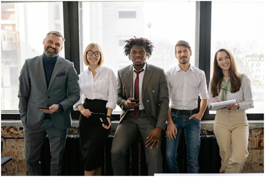 A diverse group of professionals smiling and posin