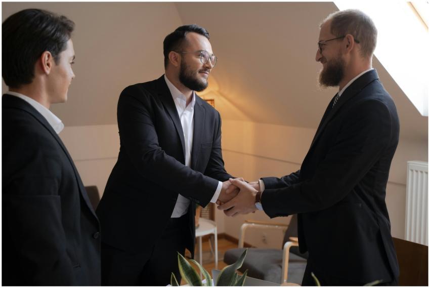Three businessmen shaking hands in a professional