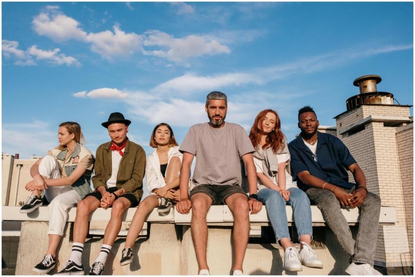 Group of friends sitting on a rooftop enjoying a w