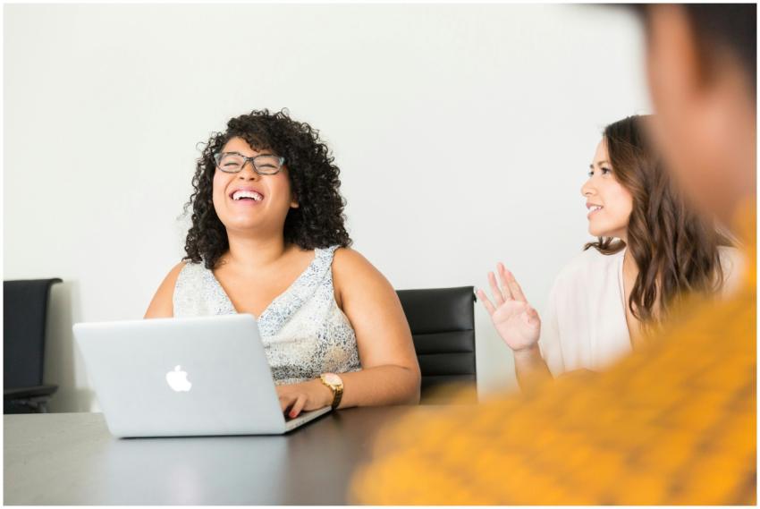 Professional women engaged in a lively meeting at