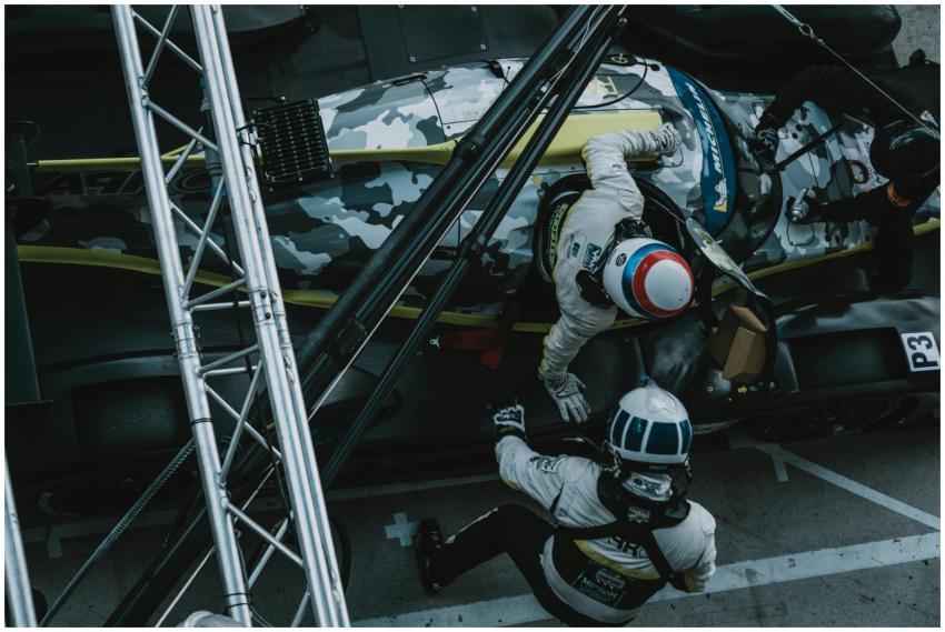 A dynamic overhead view of a pit stop during a for