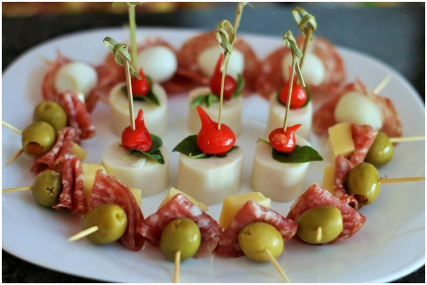 Close-up of gourmet skewers with olives, cheese, a