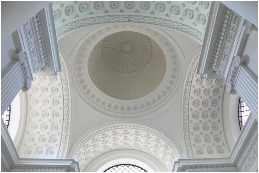 A stunning view of an ornate white dome ceiling wi
