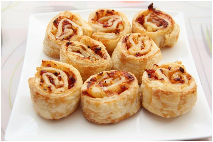 Tasty savory puff pastry rolls with cheese and bac