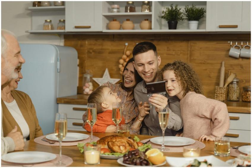 A cheerful family enjoying a festive dinner with c