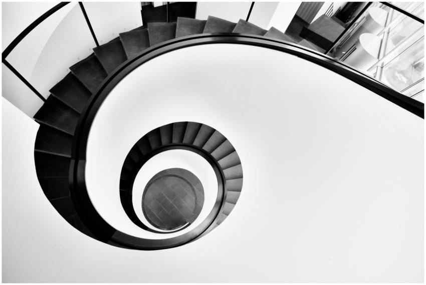 Artistic black and white photo of a spiral stairca
