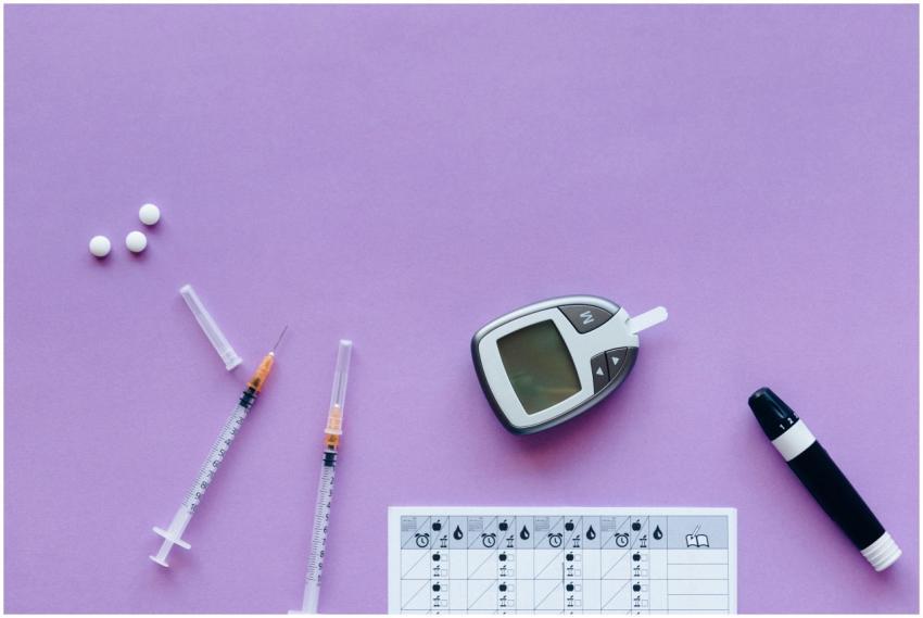 Flat lay of diabetes management tools including gl