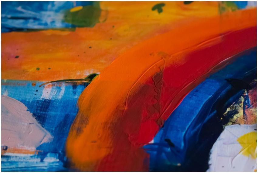 A close-up of vibrant abstract brushstrokes with b