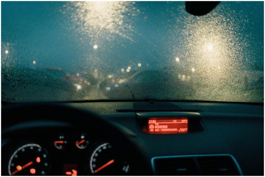 View from car interior with raindrops on windshiel