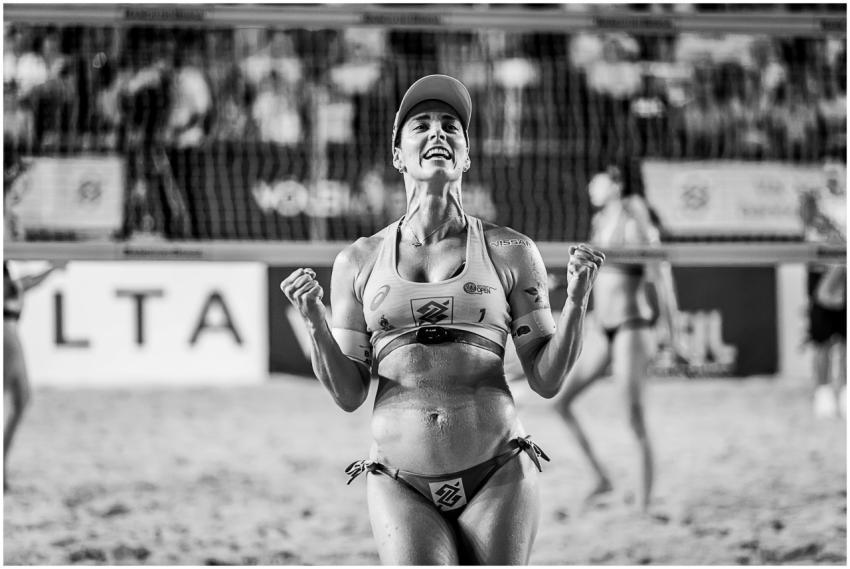 Joyful athlete celebrating a win at a beach volley